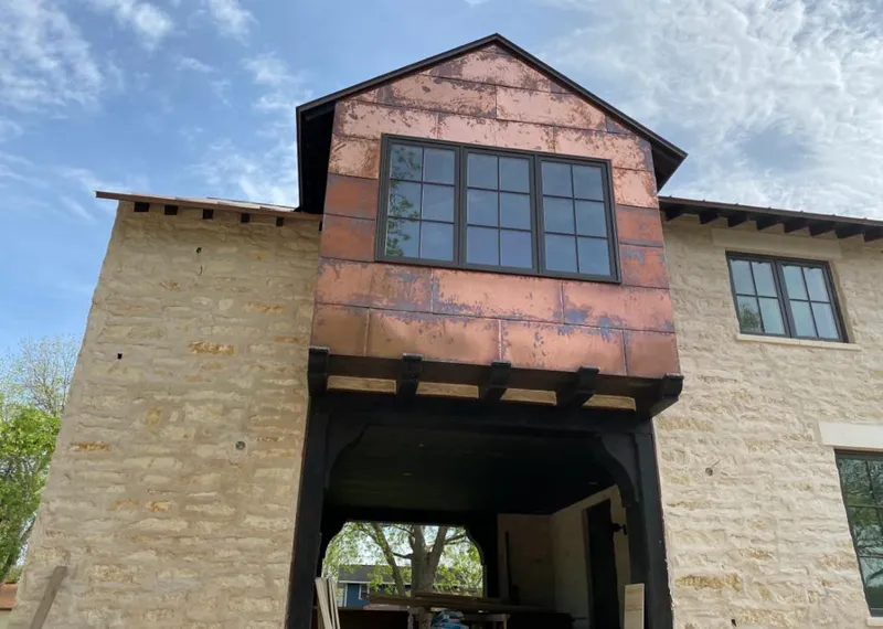 Copper metal panel facade on a stone building for Metal Roof Coating in Elk Plain